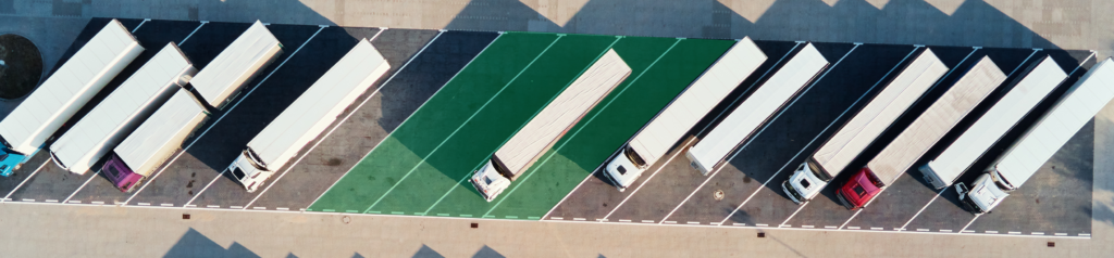 Aerial view of truck parking lot with spaces occupied and unoccupied. 